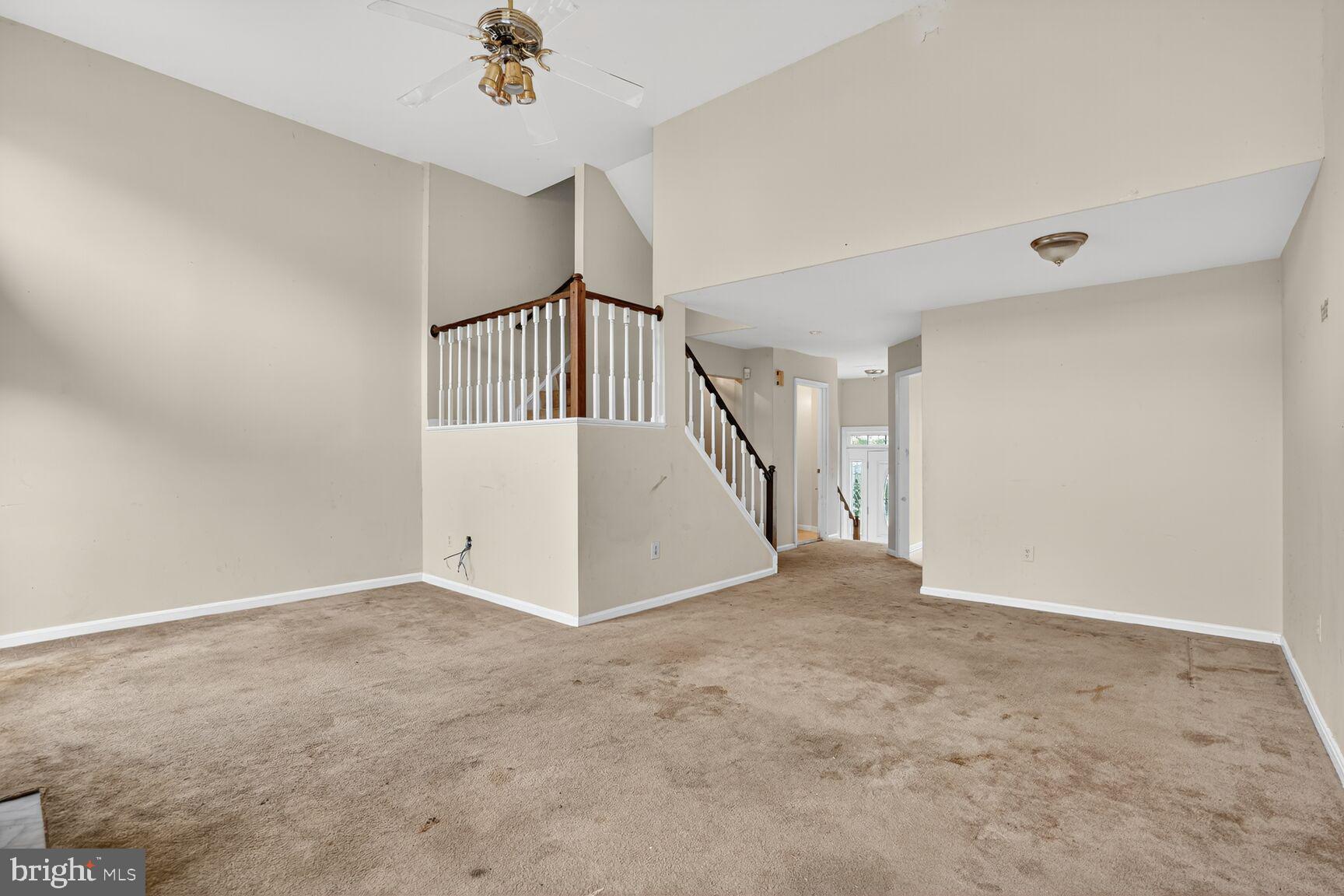 13920 Baton Rouge Court Centreville, VA 20121 - Photo 10 of 24 an empty room with windows and stairs