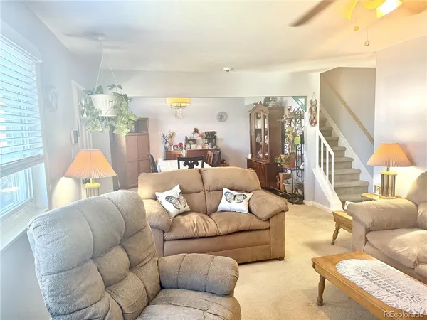 a living room with furniture and a chandelier
