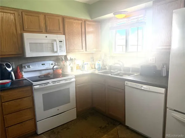 a kitchen with appliances cabinets and a sink