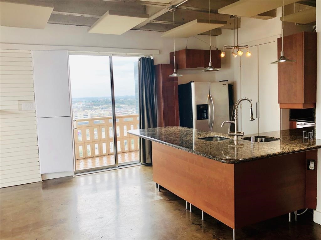 2016 Main Street, Unit 1822 Houston, TX 77002 - Photo 1 of 20 a kitchen with stainless steel appliances granite countertop a sink window and cabinets