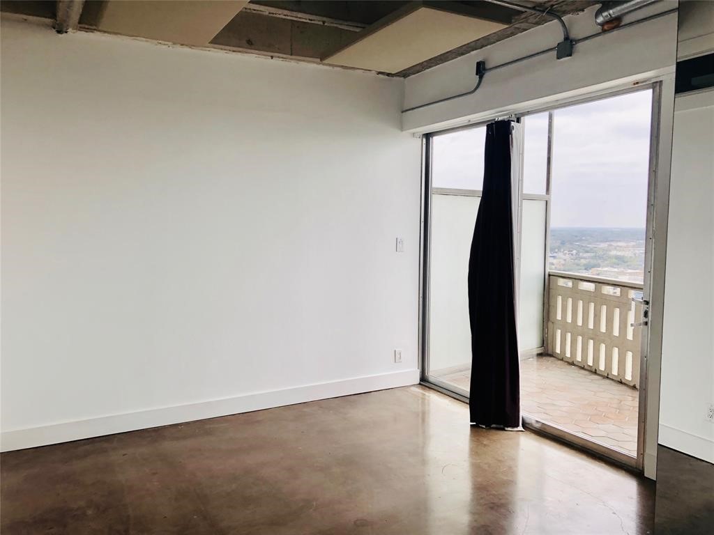 2016 Main Street, Unit 1822 Houston, TX 77002 - Photo 13 of 20 a view of an empty room with wooden floor and a window