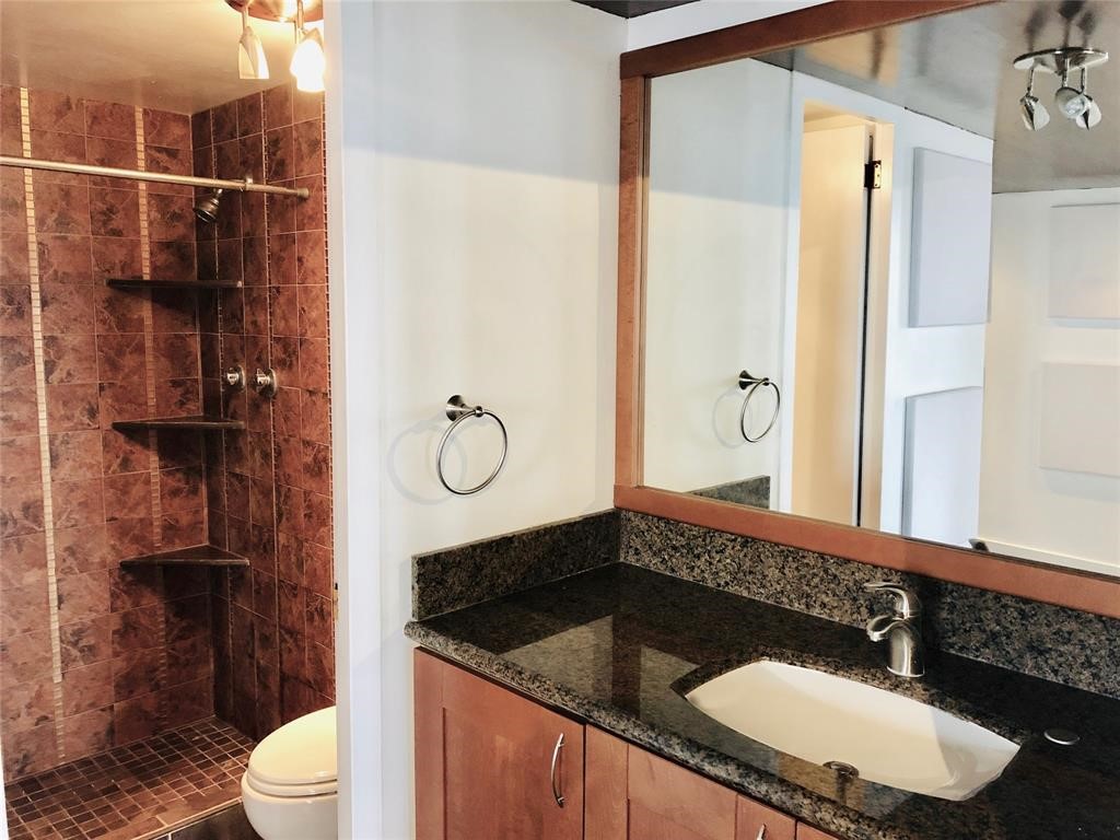 2016 Main Street, Unit 1822 Houston, TX 77002 - Photo 15 of 20 a bathroom with a sink a toilet and shower