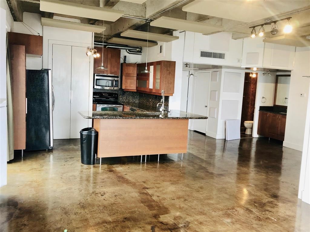 2016 Main Street, Unit 1822 Houston, TX 77002 - Photo 2 of 20 a room with wooden floor and furniture