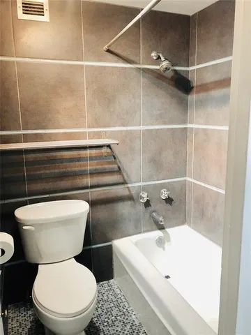a white toilet sitting next to a bathroom sink