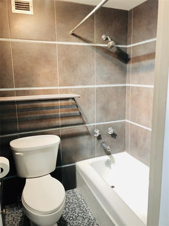 2016 Main Street, Unit 1822 Houston, TX 77002 - Photo 10 of 20 a white toilet sitting next to a bathroom sink