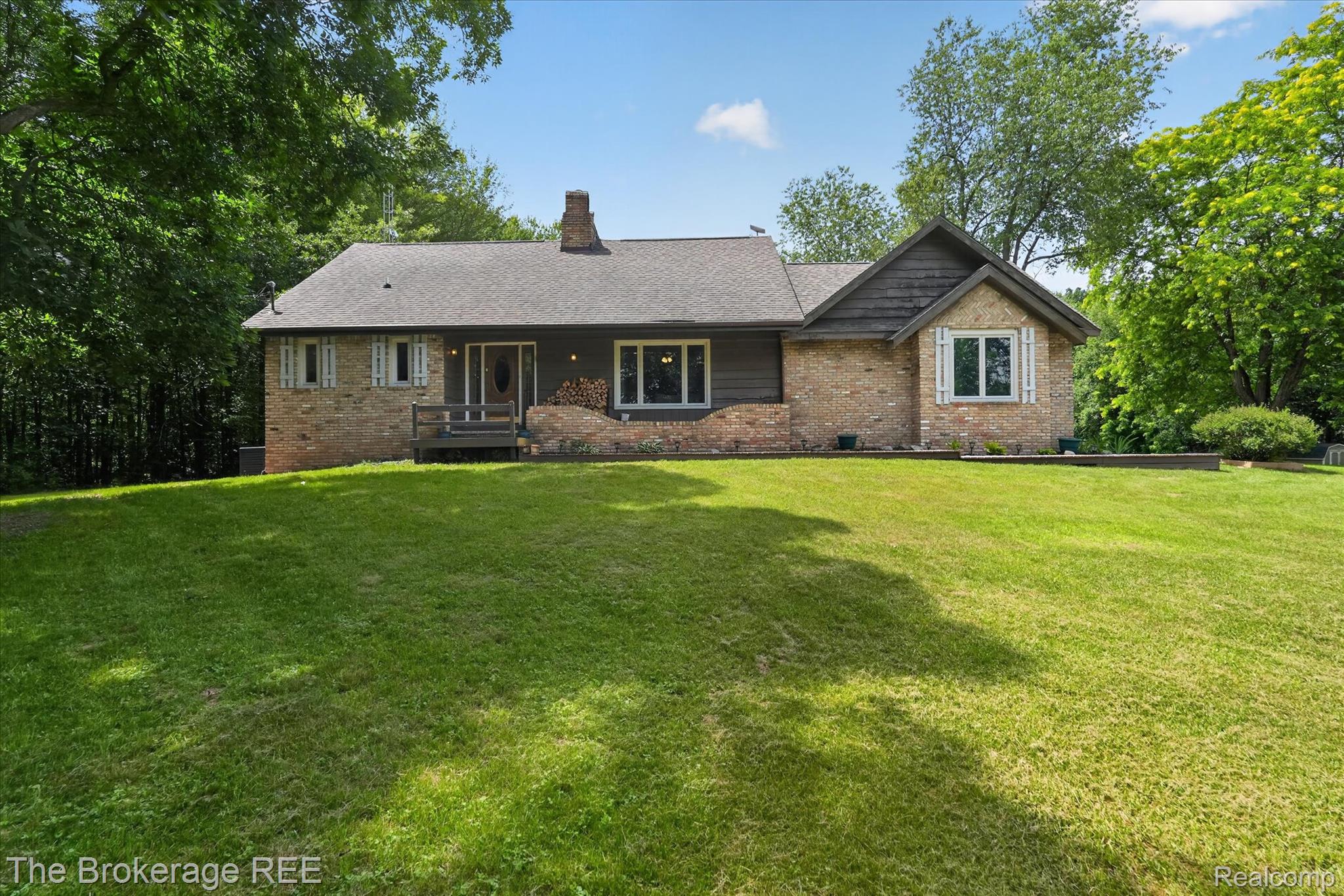 13269 North Genesee Road Clio, MI 48420 - Photo 1 of 67 Single-story residence featuring a brick facade with dark siding accents and a contrasting roof