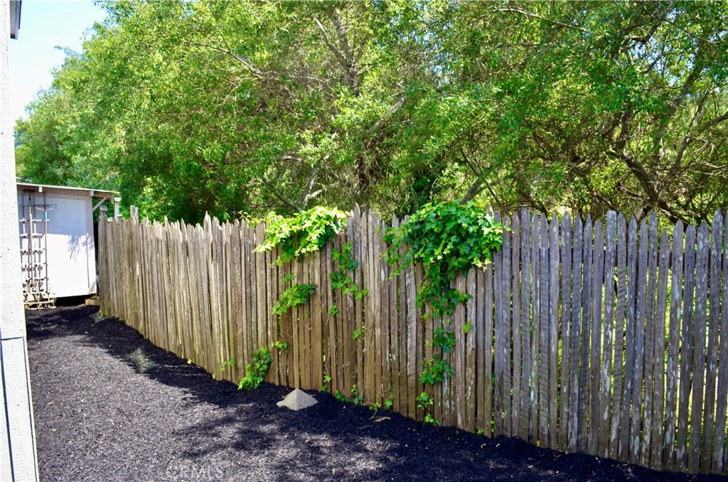 1226 Main Street, Unit 31 Cambria, CA 93428 - Photo 11 of 52 a view of a backyard with wooden fence