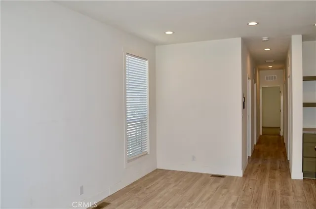 a kitchen with kitchen island a stove and a wooden floor