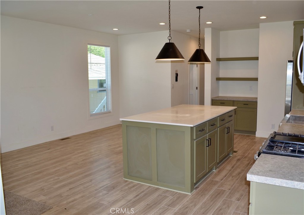 1226 Main Street, Unit 31 Cambria, CA 93428 - Photo 20 of 52 a kitchen with a stove and a wooden floor
