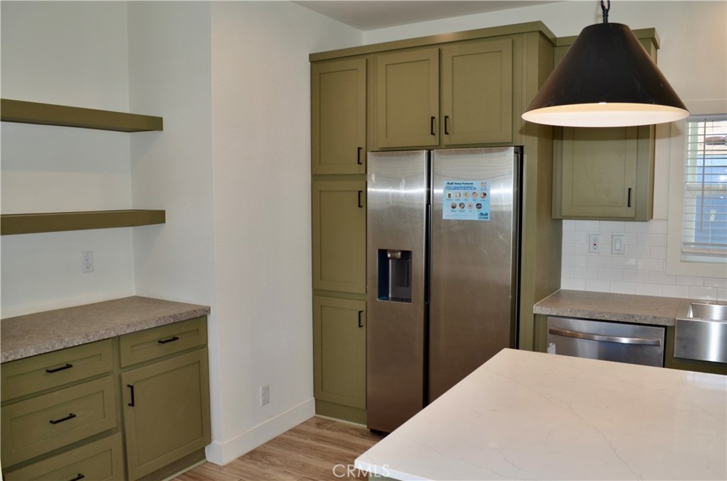 1226 Main Street, Unit 31 Cambria, CA 93428 - Photo 21 of 52 a kitchen with a refrigerator and cabinets