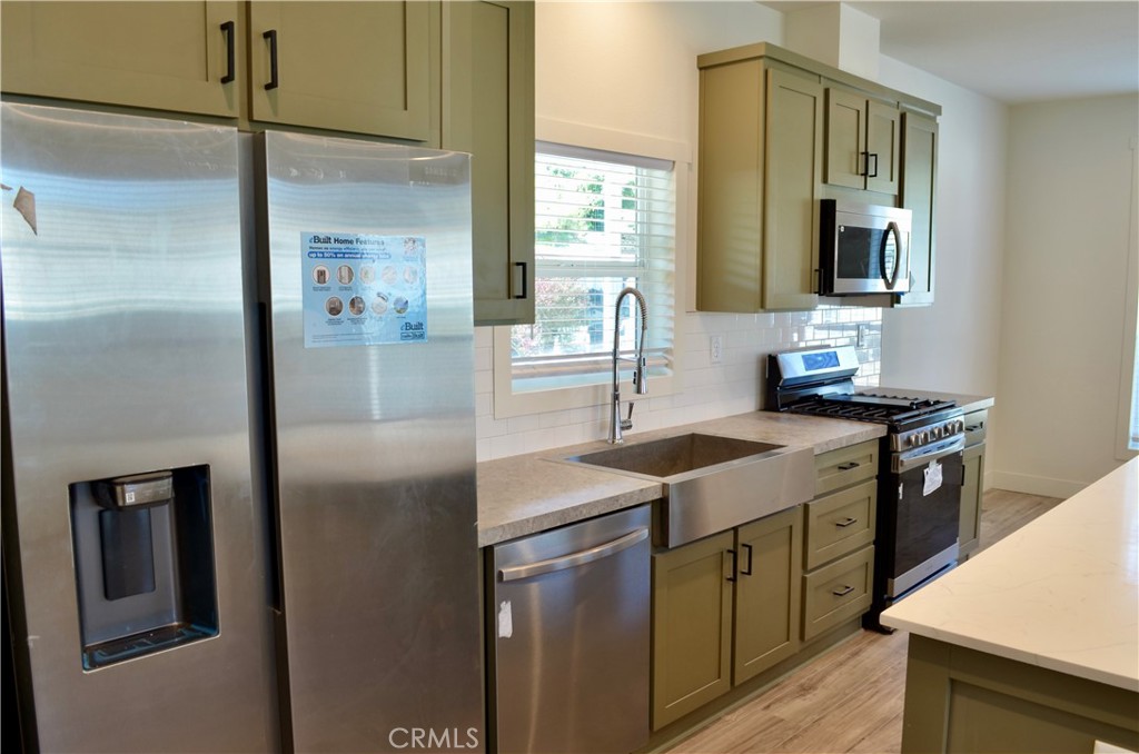 1226 Main Street, Unit 31 Cambria, CA 93428 - Photo 23 of 52 a kitchen with stainless steel appliances granite countertop a sink stove and refrigerator