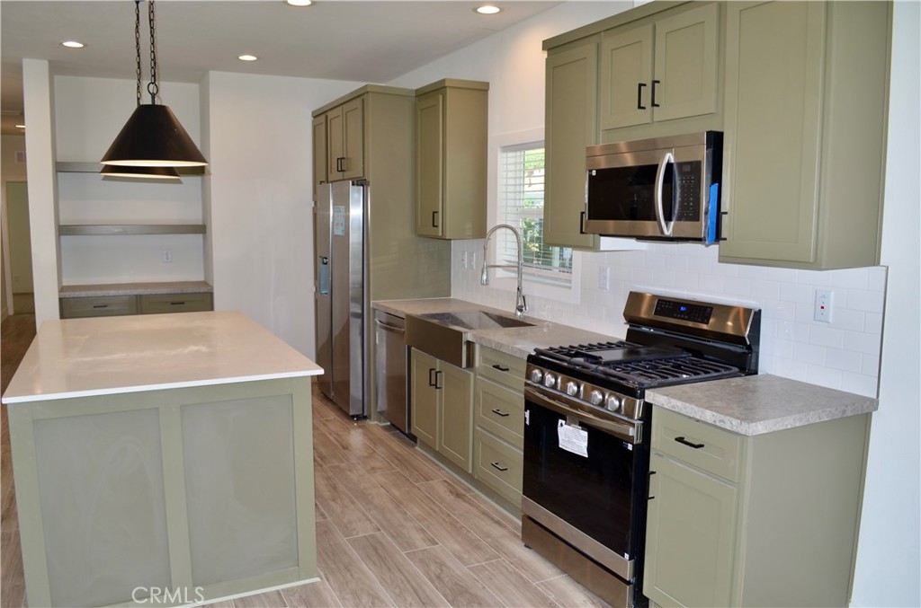 1226 Main Street, Unit 31 Cambria, CA 93428 - Photo 24 of 52 a kitchen with stainless steel appliances a stove microwave and refrigerator