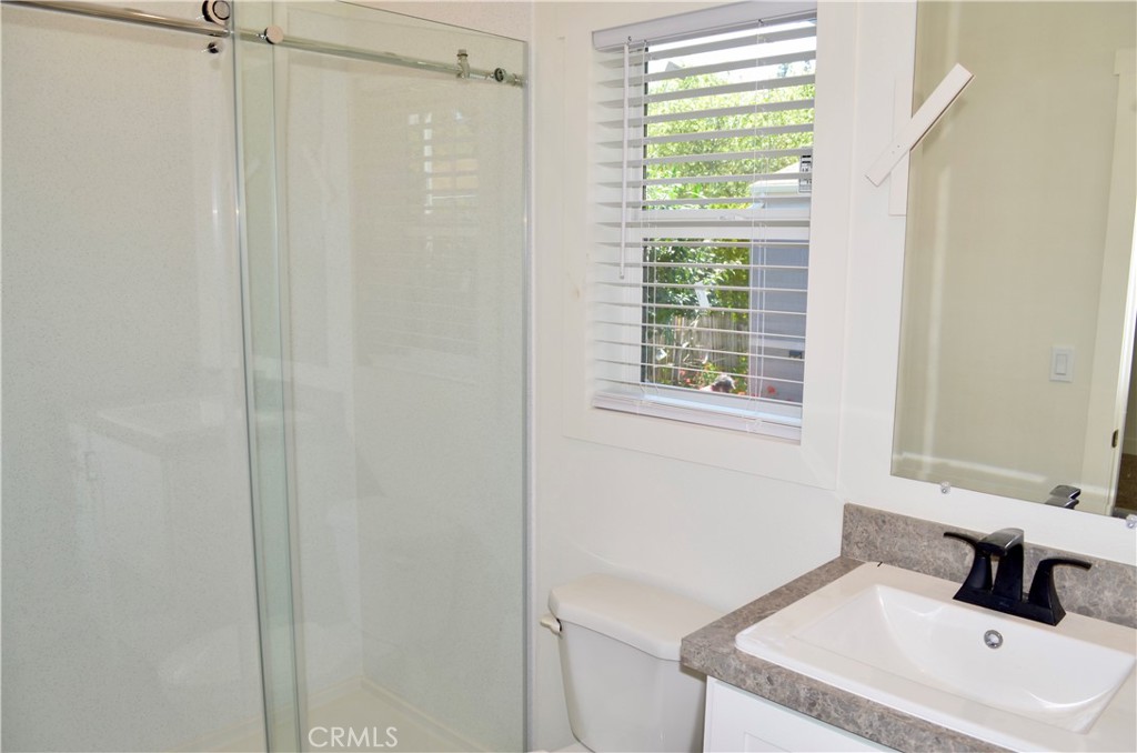 1226 Main Street, Unit 31 Cambria, CA 93428 - Photo 44 of 52 a bathroom with a sink a window and a mirror