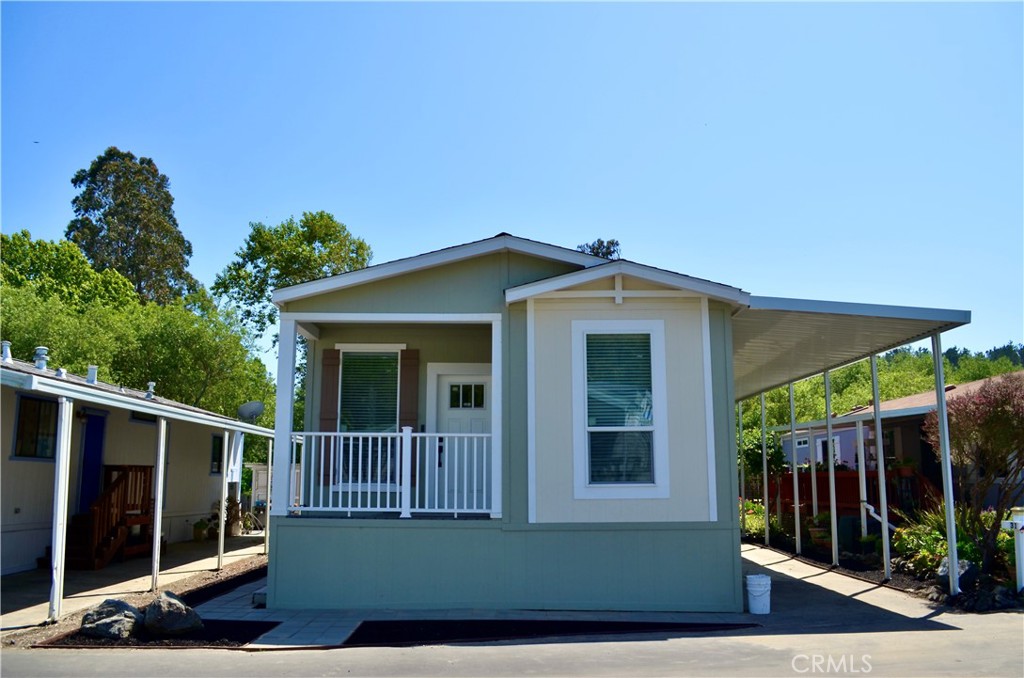 1226 Main Street, Unit 31 Cambria, CA 93428 - Photo 7 of 52 a view of a house with a small yard and floor to ceiling window