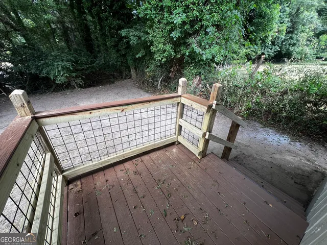 a view of a roof deck with wooden floor and fence