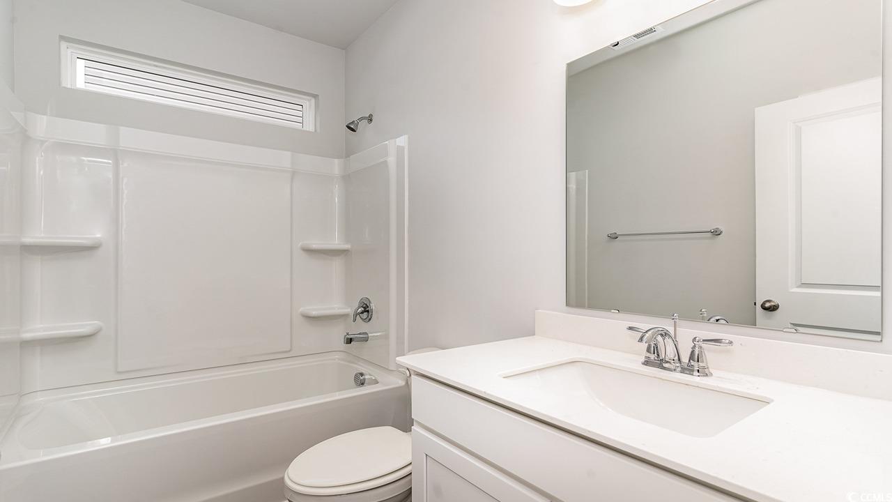 129 Fair Meadow Loris, SC 29569 - Photo 6 of 24 Full bathroom with vanity, shower combination, and toilet