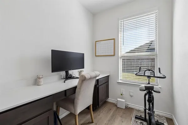 a view of a workspace with furniture and a window
