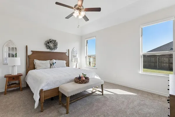 a bedroom with a bed and a painting on the wall
