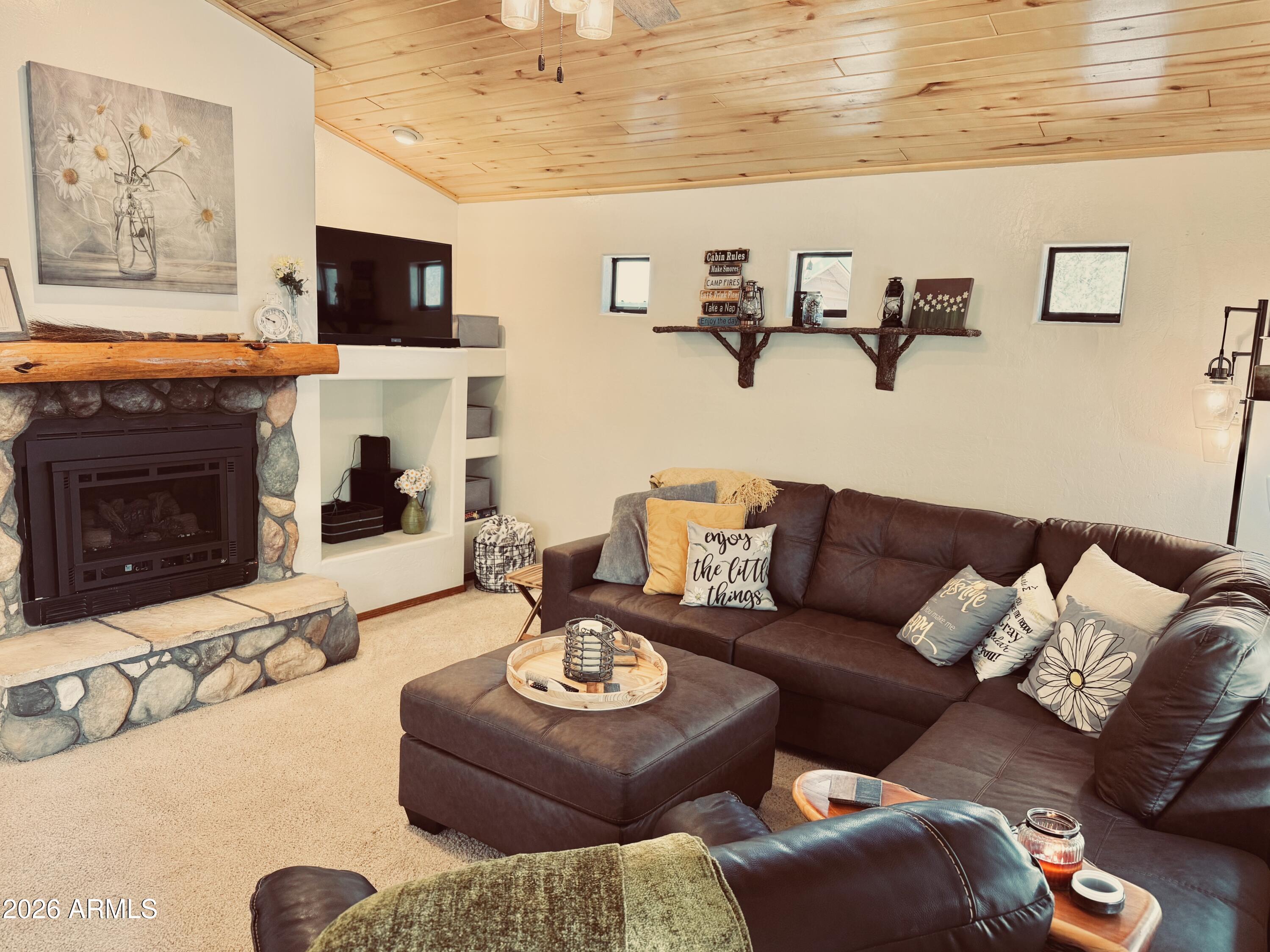 2644 Lodge Loop Overgaard, AZ 85933 - Photo 8 of 34 a living room with furniture a fireplace and a flat screen tv