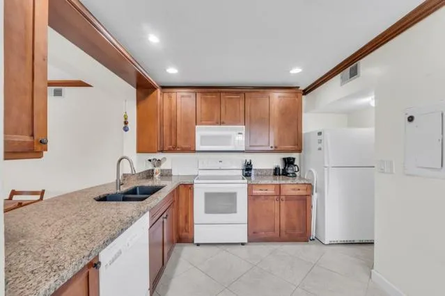 a kitchen with a stove top oven sink and cabinets