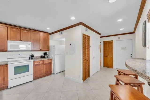 a kitchen with stainless steel appliances granite countertop a stove and a refrigerator