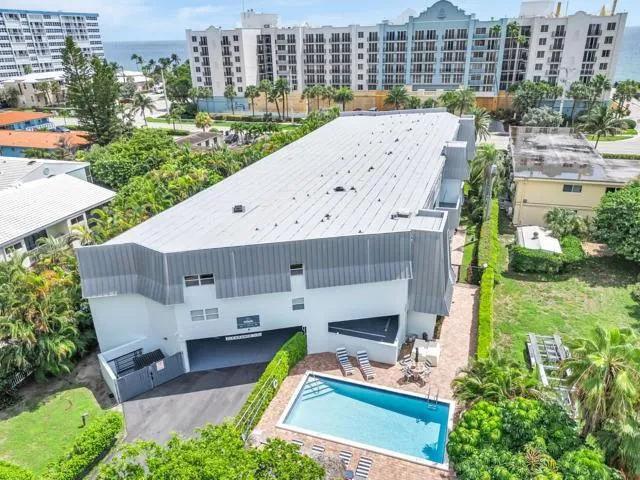 an aerial view of a house with a garden and plants