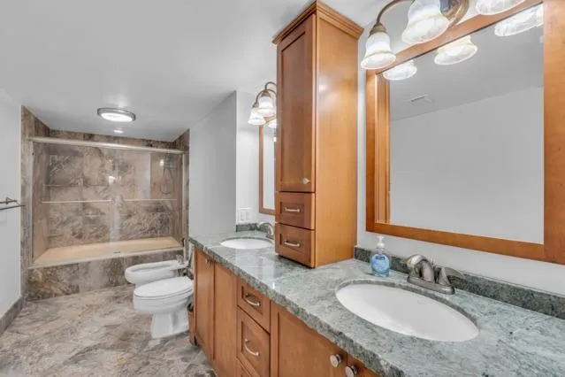 a bathroom with a granite countertop sink and a mirror