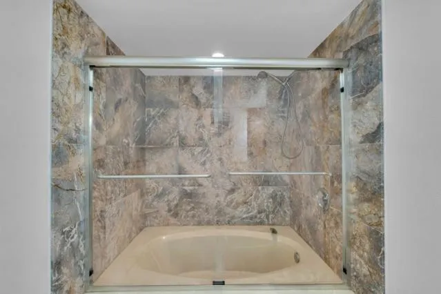 a bedroom with a bed window and a ceiling fan