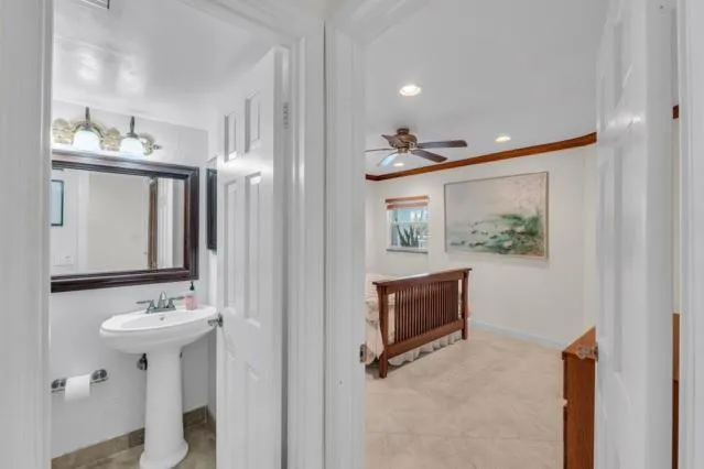 a bathroom with a sink vanity mirror and toilet