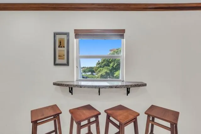 a dining room with furniture and a window