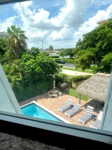 a view of a backyard and floor to ceiling window
