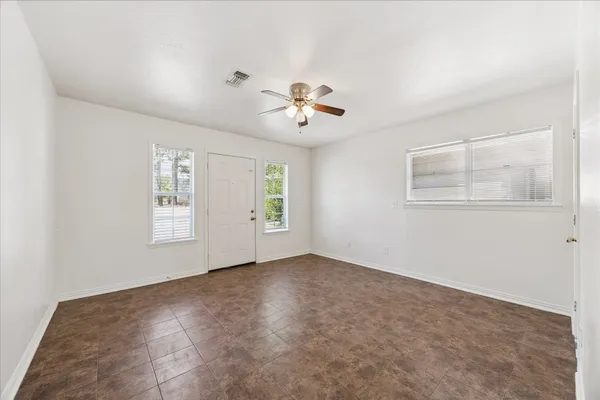 a view of room with a ceiling fan and hardwood floor