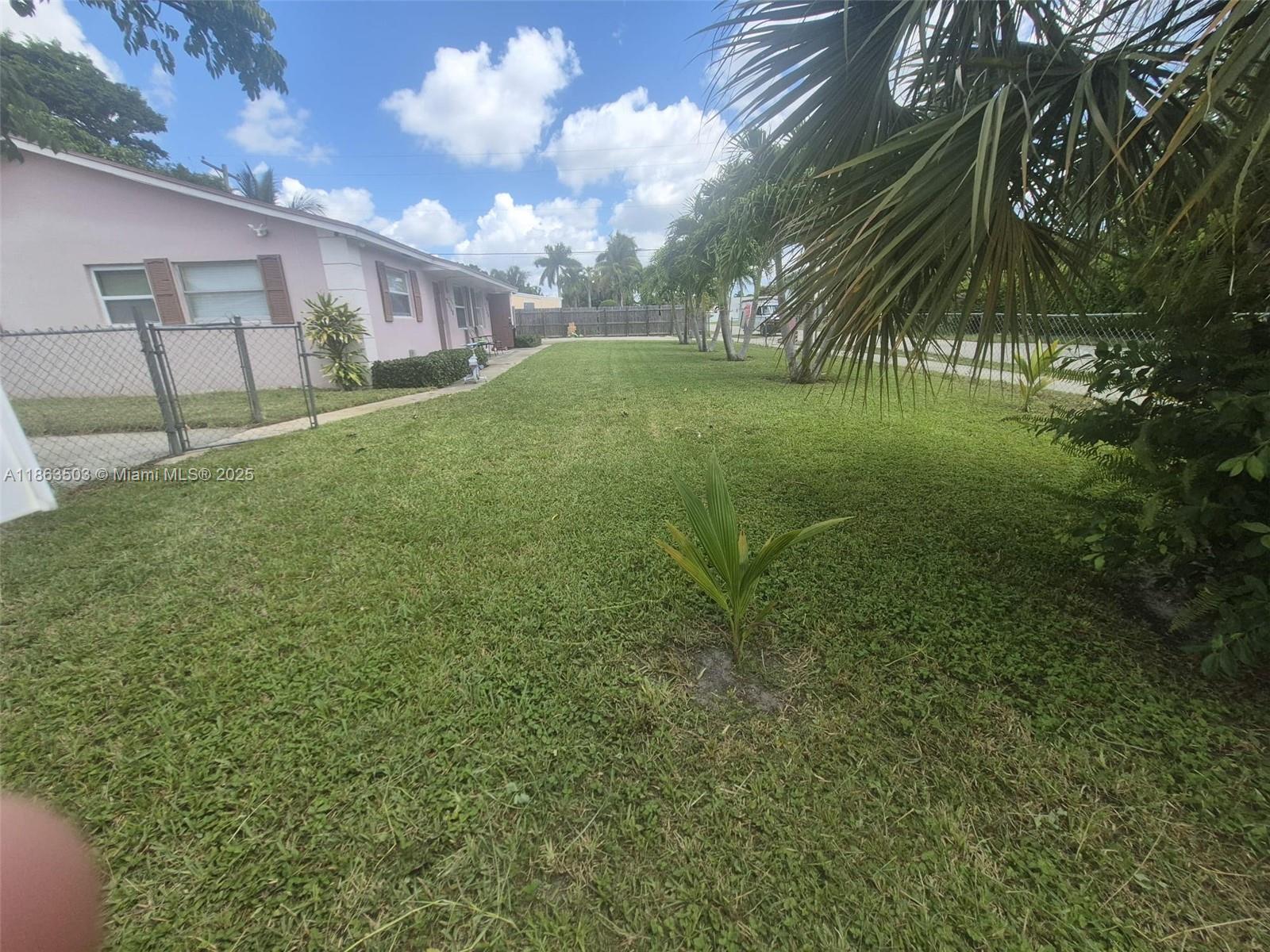 7756 Washington Avenue, Unit 7758 Lake Worth, FL 33462 - Photo 2 of 15 a view of a big yard