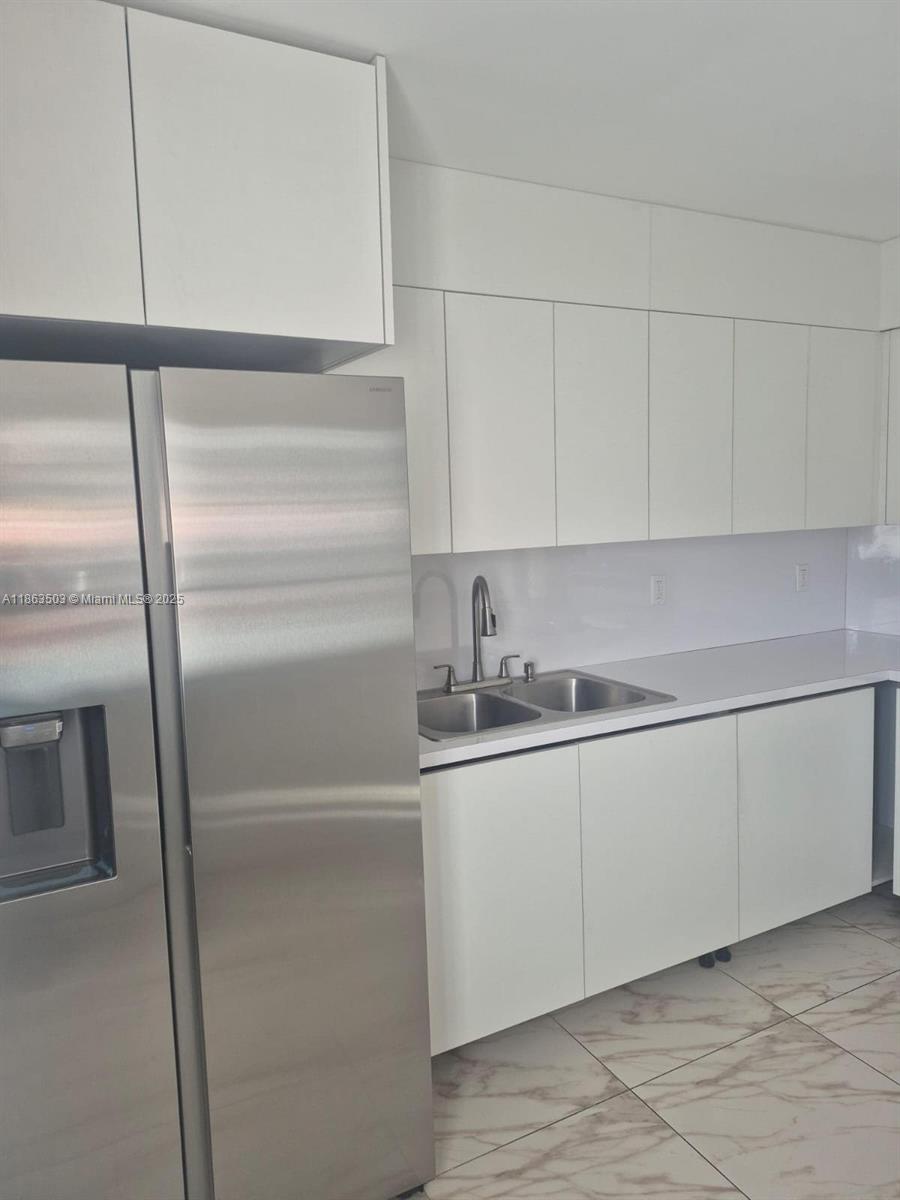 7756 Washington Avenue, Unit 7758 Lake Worth, FL 33462 - Photo 6 of 15 a kitchen with a sink and cabinets