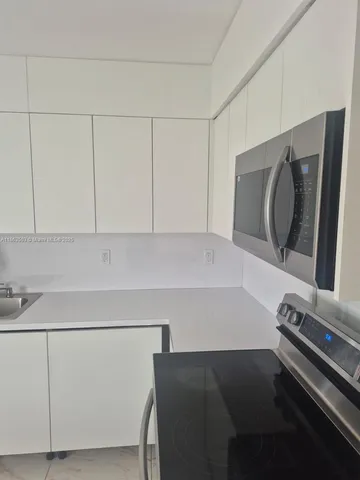 a bathroom with a sink and a washer dryer