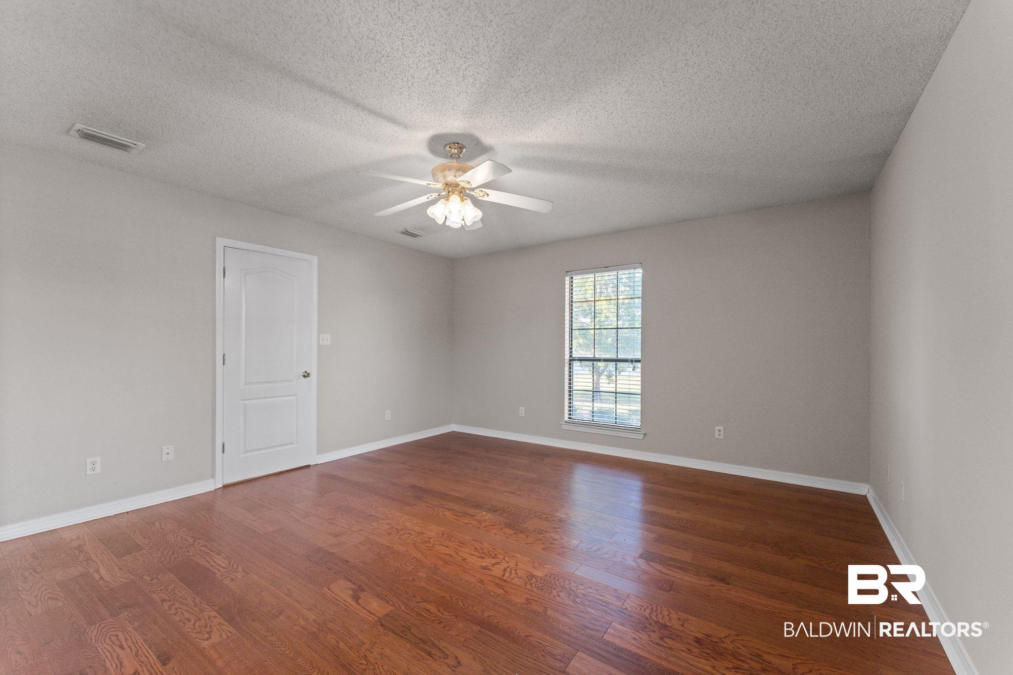 888 Mobile Cut-Off Road St. Stephens, AL 36569 - Photo 49 of 54 Empty room featuring a textured ceiling, dark wood finished floors, and ceiling fan