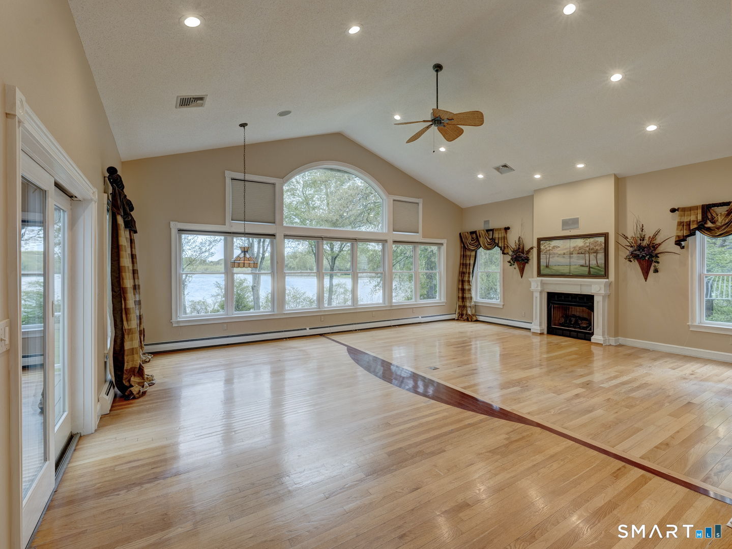 501 Highland Street Wethersfield, CT 06109 - Photo 11 of 38 an empty room with wooden floor fireplace and windows
