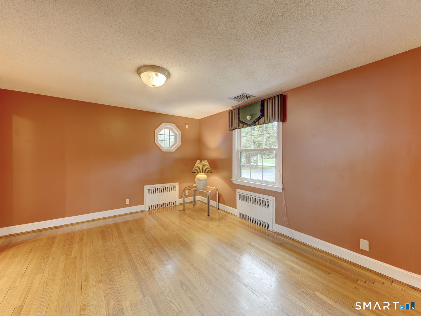 501 Highland Street Wethersfield, CT 06109 - Photo 16 of 38 a view of an empty room with a window and wooden floor
