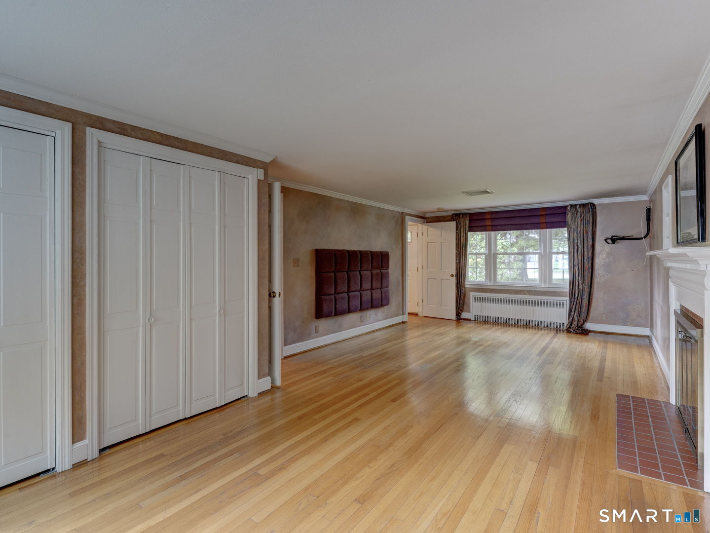 501 Highland Street Wethersfield, CT 06109 - Photo 20 of 38 a view of an empty room with wooden floor and a window