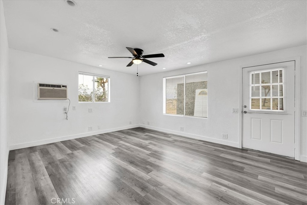 57726 Starlight Mesa Road Yucca Valley, CA 92284 - Photo 11 of 75 a view of empty room with wooden floor and fan