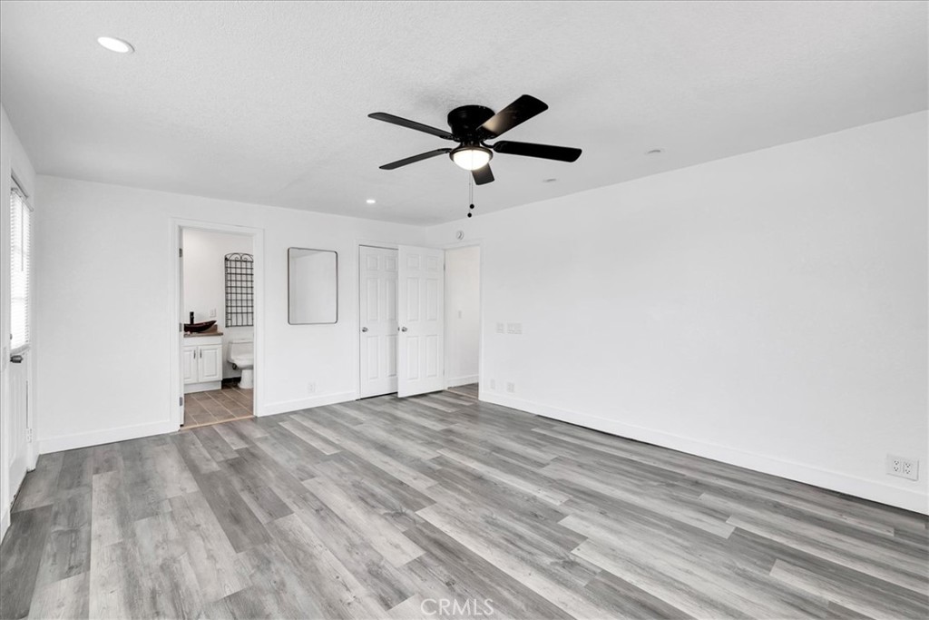 57726 Starlight Mesa Road Yucca Valley, CA 92284 - Photo 13 of 75 a view of empty room with wooden floor and ceiling fan