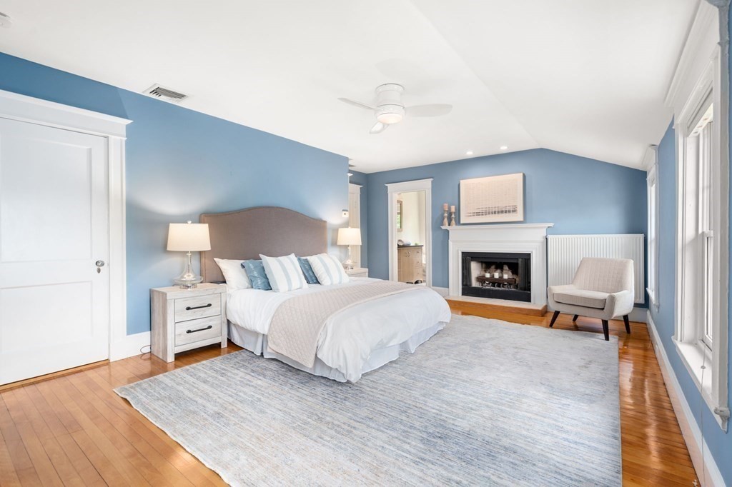25 Windsor Road Brookline, MA 02445 - Photo 12 of 31 a spacious bedroom with a bed and a fireplace