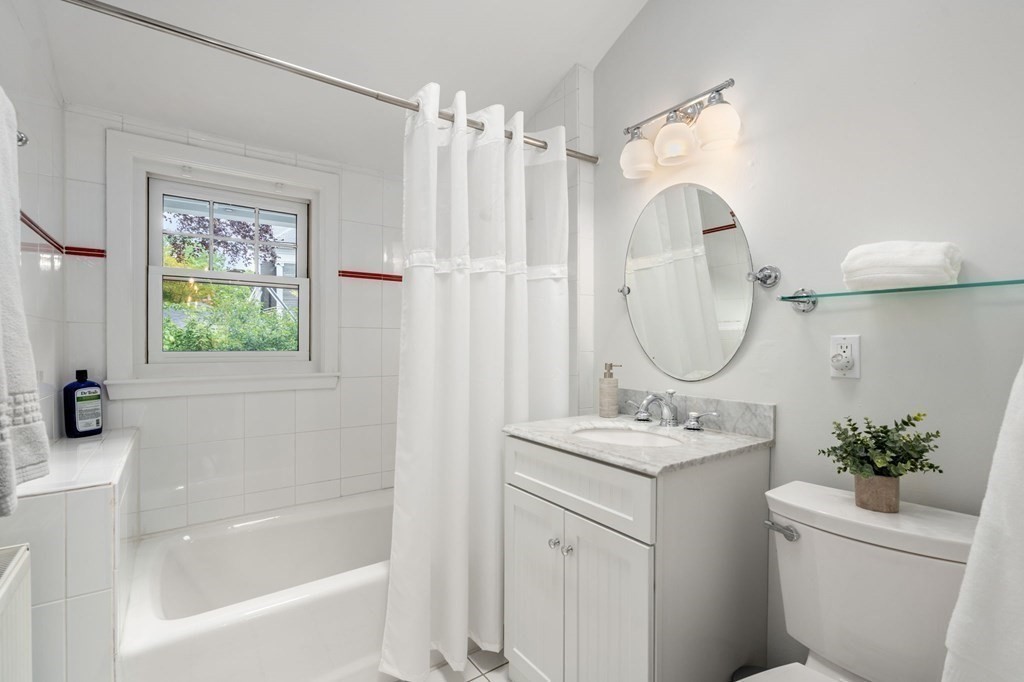 25 Windsor Road Brookline, MA 02445 - Photo 16 of 31 a bathroom with a sink toilet a tub and a mirror