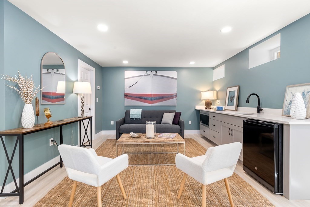25 Windsor Road Brookline, MA 02445 - Photo 21 of 31 a living room with fireplace furniture and a wooden floor