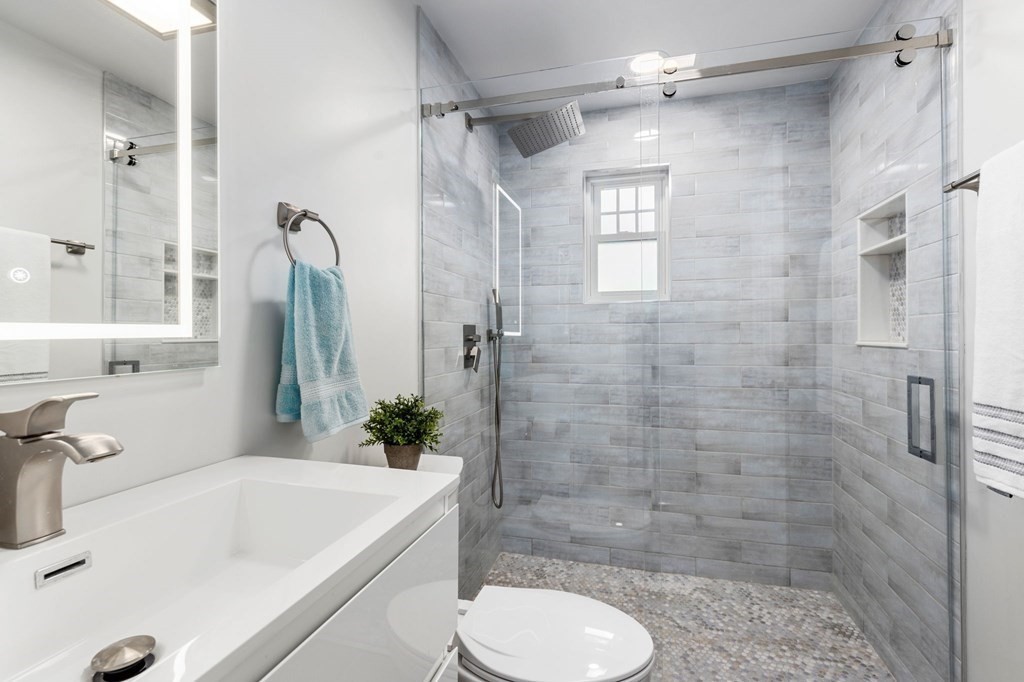 25 Windsor Road Brookline, MA 02445 - Photo 23 of 31 a bathroom with a sink toilet and shower
