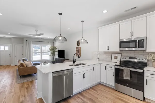 a kitchen with a sink stove and microwave