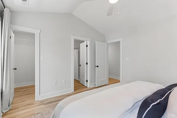 a bedroom with a bed and wooden floor