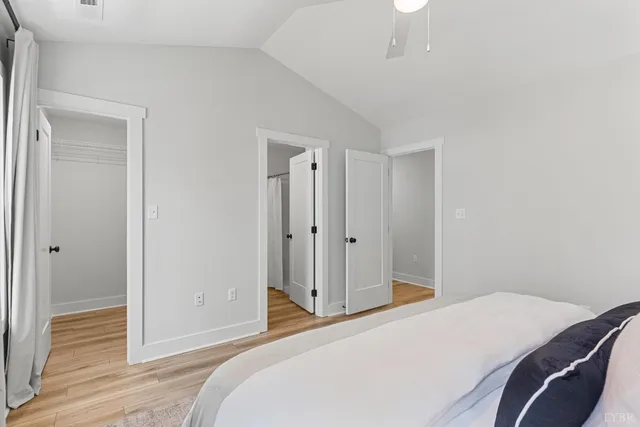 a bedroom with a bed and wooden floor