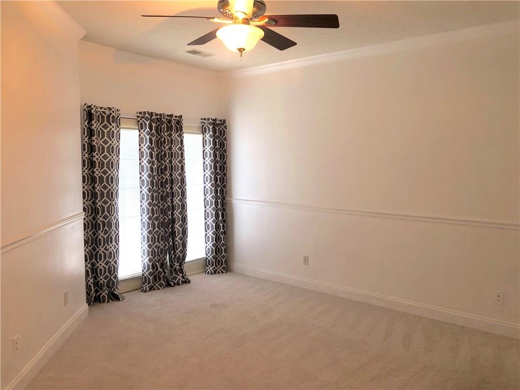 211 Adams Pointe Boulevard, Unit 10 Mars, PA 16046 - Photo 13 of 33 an empty room with windows and ceiling fan