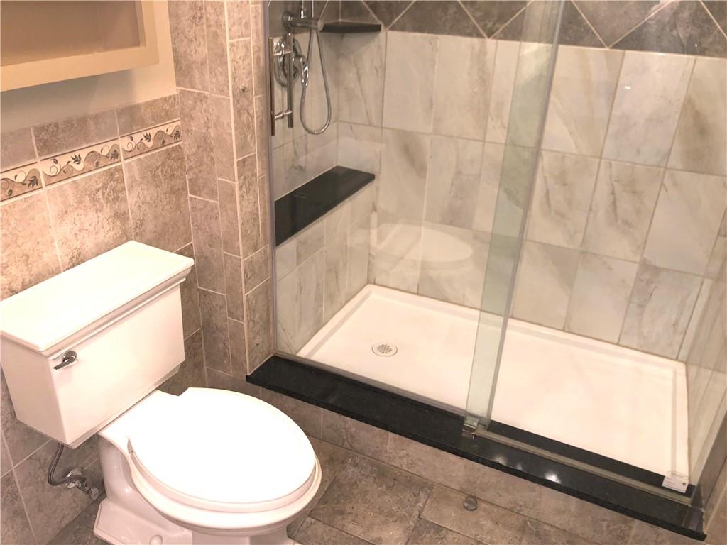 211 Adams Pointe Boulevard, Unit 10 Mars, PA 16046 - Photo 15 of 33 a bathroom with a toilet and a shower